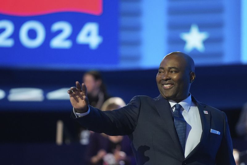 Jaime Harrison, chair of the Democratic National Committee, waves during the Democratic National Convention Monday, Aug. 19, 2024, in Chicago. (AP Photo/Erin Hooley)