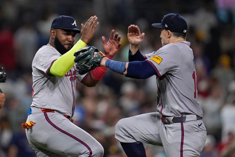 Atlanta Braves designated hitter Marcell Ozuna, e, celebrates with teammate right fielder Adam Duvall after the Braves defeated the San Diego Padres 6-1 in a baseball game Friday, July 12, 2024, in San Diego. (AP Photo/Gregory Bull)