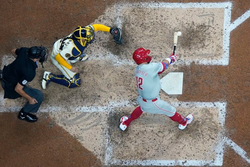 Philadelphia Phillies' Kyle Schwarber hits an RBI single during the seventh inning of a baseball game against the Milwaukee Brewers Monday, Sept. 16, 2024, in Milwaukee. (AP Photo/Morry Gash)