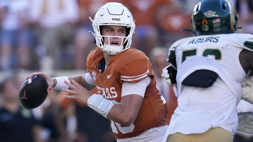 Texas quarterback Arch Manning, left, throws against Colorado State during the second half of an NCAA college football game in Austin, Texas, Saturday, Aug. 31, 2024. (AP Photo/Eric Gay)