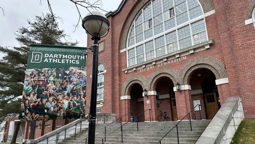 FILE - A Dartmouth Athletics banner hangs outside Alumni Gymnasium on the Dartmouth University campus in Hanover, N.H., March 5, 2024. (AP Photo/Jimmy Golen, File)