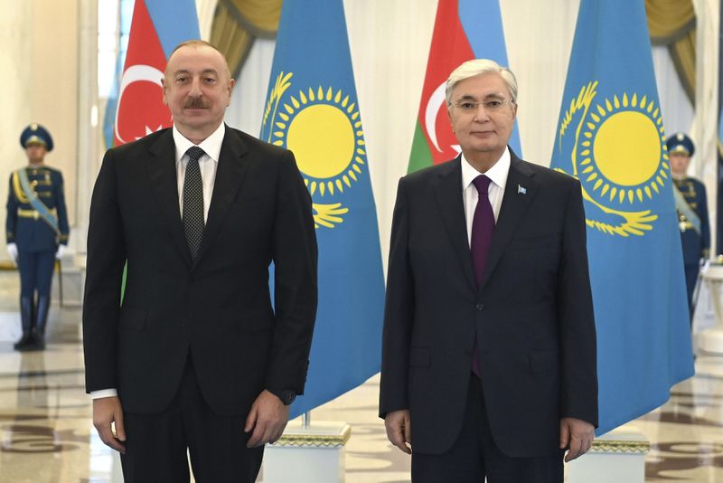 In this photo released by Kazakhstan's Presidential Press Office, President Kassym-Jomart Tokayev, right, and Azerbaijani President Ilham Aliyev pose for a photo during their meeting on the sidelines of the Shanghai Cooperation Organisation (SCO) summit in Astana, Kazakhstan, on Wednesday, July 3, 2024. (Kazakhstan's Presidential Press Office via AP)