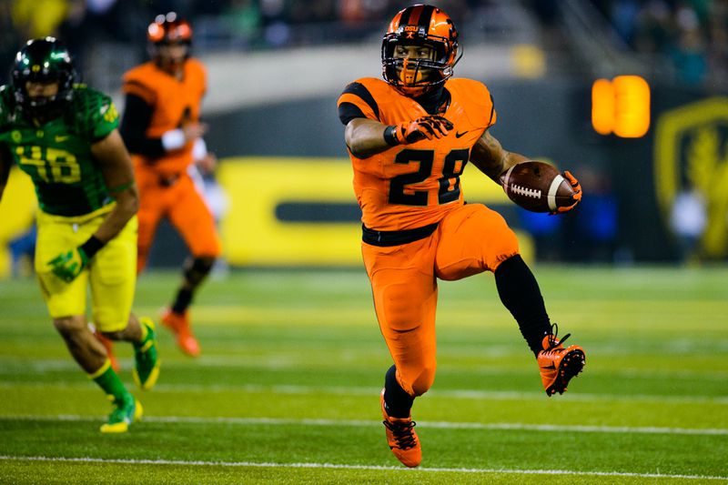 Oregon State junior running back Terron Ward (28) high-steps downfield during a carry in the third quarter. The No. 13 Oregon Ducks play the Oregon St. Beavers at Autzen Stadium in Eugene, Ore. on Nov. 29, 2013. (Michael Arellano/Emerald)
