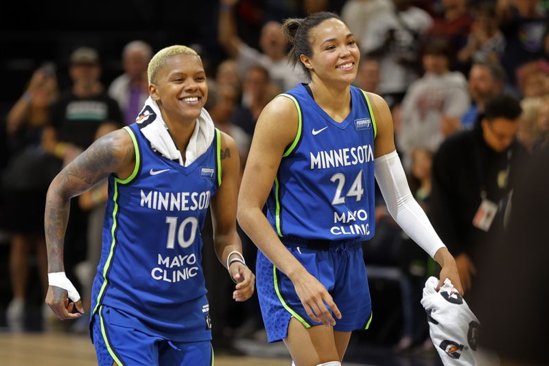 Minnesota Lynx guard Courtney Williams (10) and forward Napheesa Collier (24) celebrate after a win over the Chicago Sky in a WNBA basketball game Friday, Sept. 13, 2024, in Minneapolis. (AP Photo/Bruce Kluckhohn)