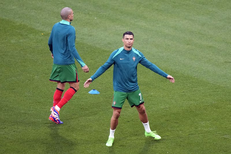 Portugal's Cristiano Ronaldo (7) warms up before a Group F match between Portugal and Czech Republic at the Euro 2024 soccer tournament in Leipzig, Germany, Tuesday, June 18, 2024. (AP Photo/Sergei Grits)