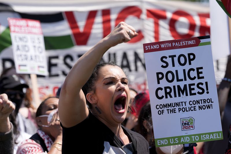 A protester yells during a demonstration before a march to the Democratic National Convention Monday, Aug. 19, 2024, in Chicago. (AP Photo/Alex Brandon)