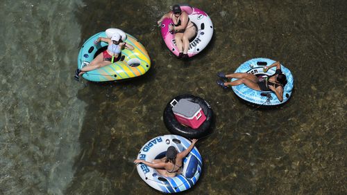 Tubers float the cool Comal River as temperatures in South Texas hit triple-digit numbers, Wednesday, Aug. 21, 2024, in New Braunfels, Texas. (AP Photo/Eric Gay)