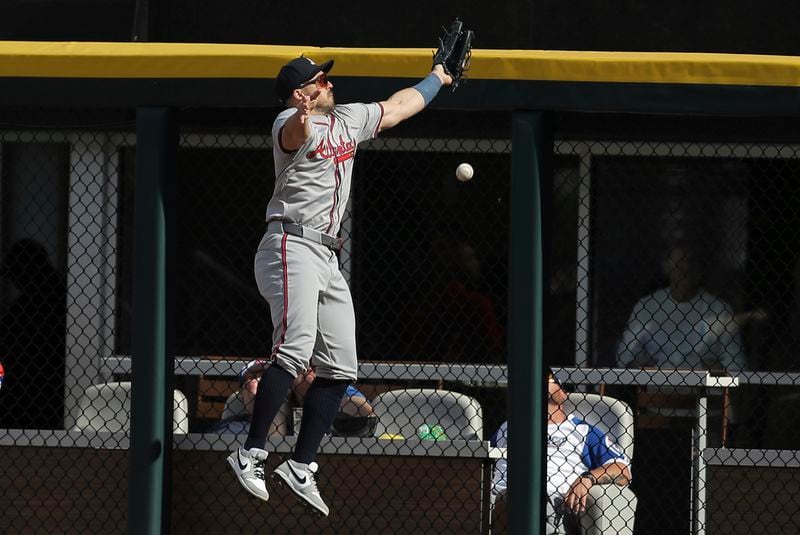 Atlanta Braves outfielder Adam Duvall misses the ball against the fence off a Chicago White Sox's Andrew Vaughn double during the sixth inning of a baseball game against the Chicago White Sox Thursday, June 27, 2024, in Chicago. (AP Photo/Melissa Tamez)
