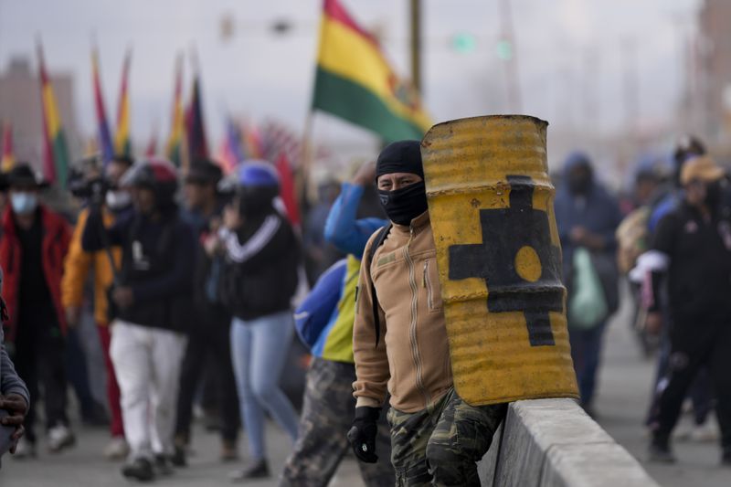 Supporters of Bolivia's President Luis Arce block supporters of former President Evo Morales from passing as they march to the capital to protest the Arce's government in El Alto, Bolivia, Sunday, Sept. 22, 2024. (AP Photo/Juan Karita)