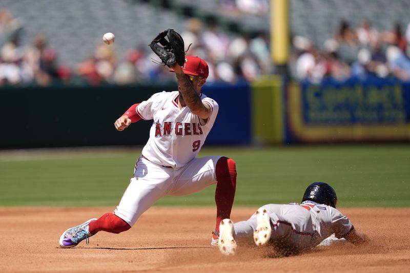 Atlanta Braves' Whit Merrifield, right, steals second against Los Angeles Angels shortstop Zach Neto during the third inning of a baseball game, Sunday, Aug. 18, 2024, in Anaheim, Calif. (AP Photo/Ryan Sun)