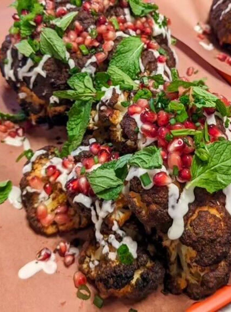 Whole-roasted cauliflower with pomegranate is one of a handful of vegetarian options at Gene's in Atlanta's East Lake neighborhood. / Courtesy of Gene's