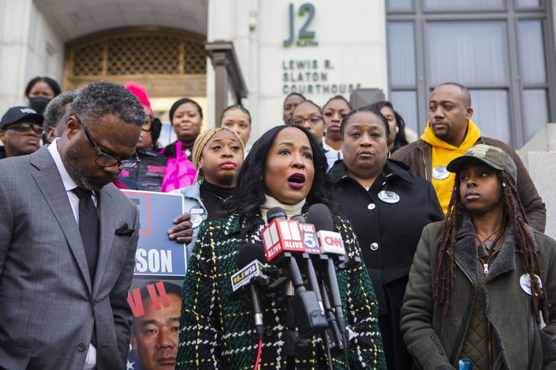 Attorney Tanya Miller, center, speaks during a press conference Monday in Atlanta regarding the most recent development in the case of Jimmy Atchison, who was shot by an Atlanta police officer in 2019. CHRISTINA MATACOTTA FOR THE ATLANTA JOURNAL-CONSTITUTION