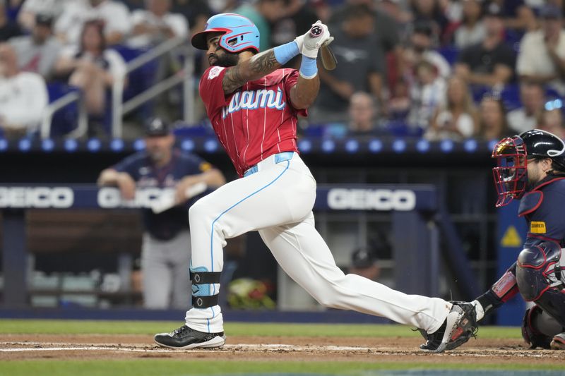 Miami Marlins' Derek Hill hits a triple during the first inning of a baseball game against the Atlanta Braves, Saturday, Sept. 21, 2024, in Miami. (AP Photo/Marta Lavandier)