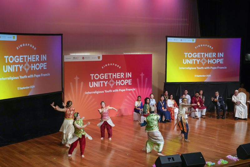 From right, Pope Francis and Singapore's Minister of Culture Edwin Tong attend an interreligious meeting with young people at the Catholic Junior College in Singapore, Friday, Sept. 13, 2024. Pope Francis is wrapping up his visit to Singapore by praising its tradition of interfaith harmony. (AP Photo/Gregorio Borgia)