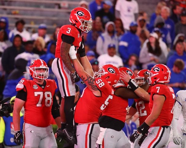 Georgia running back Andrew Paul gets a hoist from offensive lineman Austin Blaske after scoring a touchdown for a 51-13 lead over Kentucky during the fourth quarter.  Curtis Compton for the Atlanta Journal Constitution