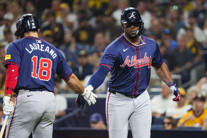 Atlanta Braves’ Jorge Soler is greeted by Ramón Laureano (18) after a solo homer against the San Diego Padres during the fifth inning of National League Division Series Wild Card Game Two at Petco Park in San Diego on Wednesday, Oct. 2, 2024.   (Jason Getz / Jason.Getz@ajc.com)