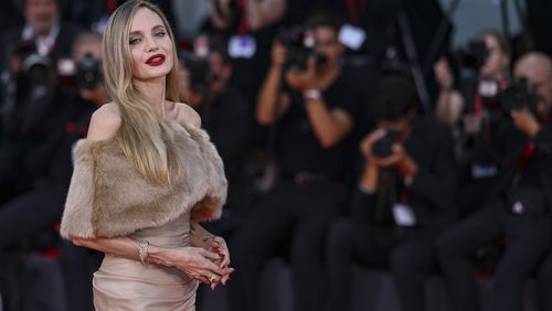 Angelina Jolie poses for photographers upon arrival for the premiere of the film 'Maria' during the 81st edition of the Venice Film Festival in Venice, Italy, on Thursday, Aug. 29, 2024. (Photo by Vianney Le Caer/Invision/AP)