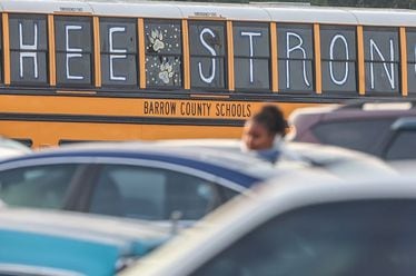 A bus outside Apalachee High School in Winder, Ga., as classes resumed after a Sept. 4 shooting there left four people dead. (John Spink/The Atlanta Journal-Constitution)