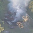 Firefighters battle a massive blaze at a Newnan home, where at least six people were killed. A 6-year-old was among the dead, the Coweta coroner's office confirmed.