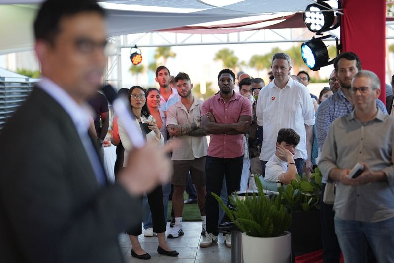 Guests look on as Uma Valeti, CEO and founder of Upside Foods, speaks during a pop-up tasting of the company's "lab-grown" meat, Thursday, June 27, 2024, in Miami. As Florida's ban on lab-grown meat is set to go into effect next week, one manufacturer hosted a tasting party, serving up cultivated chicken tostadas to dozens of attendees on a rooftop in Miami's Wynwood neighborhood. (AP Photo/Rebecca Blackwell)