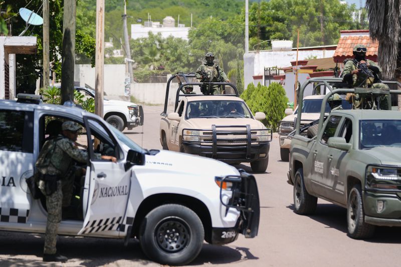 National Guard forces and Army soldiers patrol during an operation in a neighborhood of Culiacan, Sinaloa state, Mexico, Thursday, Sept. 19, 2024. (AP Photo/Eduardo Verdugo)