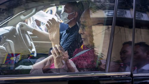 Tibetan spiritual leader the Dalai Lama greets a welcoming crowd from inside his car as he arrives in Dharamshala, India, Wednesday, Aug. 28, 2024. (AP Photo/Ashwini Bhatia)