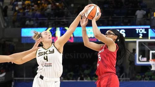 Chicago Sky's Marina Mabrey, left, blocks the shot of Atlanta Dream's Allisha Gray in the closing seconds of a WNBA basketball game Wednesday, July 10, 2024, in Chicago. The Sky won 78-69. (AP Photo/Charles Rex Arbogast)