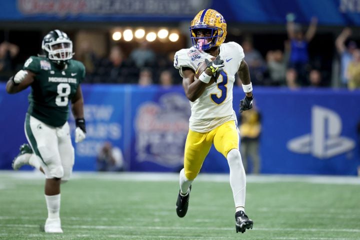 Pittsburgh Panthers wide receiver Jordan Addison (3) runs after a catch for a 52-yard gain during the first half against the Michigan State Spartans in the Chick-fil-A Peach Bowl at Mercedes-Benz Stadium in Atlanta, Thursday, December 30, 2021. JASON GETZ FOR THE ATLANTA JOURNAL-CONSTITUTION