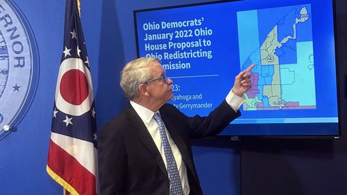 Ohio Gov. Mike DeWine points to a map during a press conference in Columbus, Ohio, Wednesday, July 31, 2024, where he opposed a fall ballot measure aimed at remaking the state's troubled political mapmaking system. If it passes, DeWine said he will work with state lawmakers next year to advance a competing amendment based on the Iowa model. (AP Photo/Julie Carr Smyth)