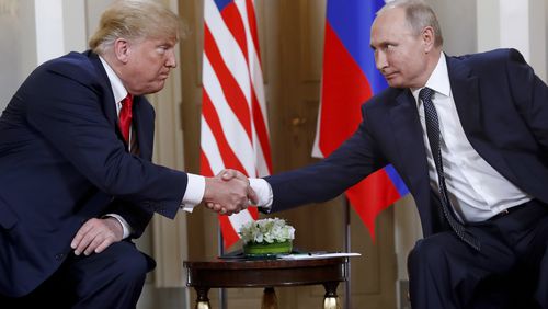 FILE - President Donald Trump, left, and Russian President Vladimir Putin shake hands at the beginning of a meeting at the Presidential Palace in Helsinki, Finland, July 16, 2018. (AP Photo/Pablo Martinez Monsivais, File)