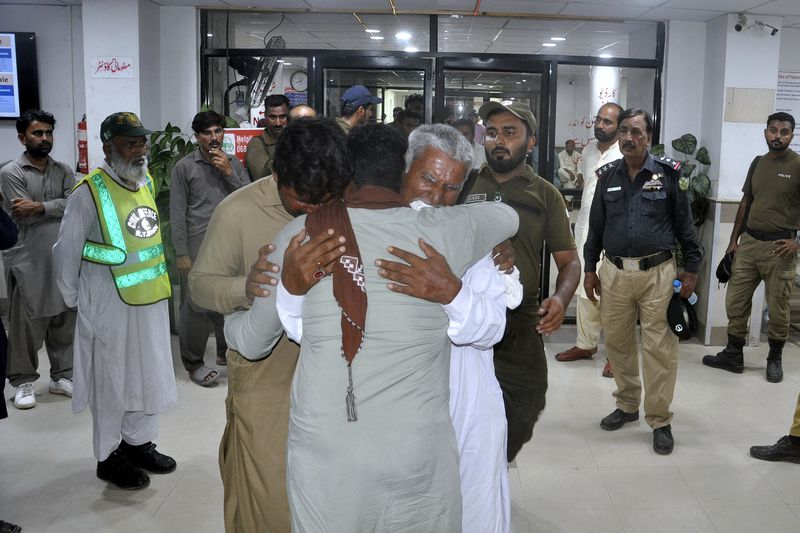 Family members of police officers, who were killed in gunmen ambush on a police convoy in a deserted area, mourn at a hospital in Rahim Yar Khan, Pakistan, Friday, Aug. 23, 2024. (AP Photo/Saddique Baloch)