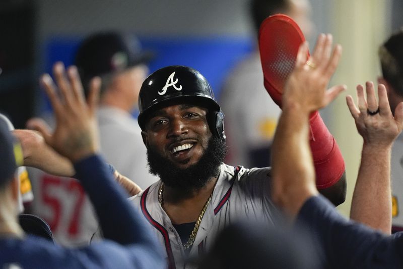 Atlanta Braves designated hitter Marcell Ozuna celebrates in the dugout after scoring off a two-run double hit by Travis d'Arnaud during the fifth inning of a baseball game against the Los Angeles Angels, Saturday, Aug. 17, 2024, in Anaheim, Calif. (AP Photo/Ryan Sun)