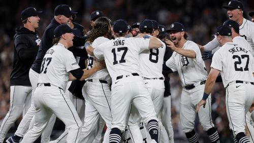 The Detroit Tigers, including Tyler Holton (87), Jace Jung (17), Matt Vierling (8), Zach McKinstry, Trey Sweeney (27) and Kerry Carpenter, celebrate after defeating the Chicago White Sox to win a wildcard spot in the major league baseball playoffs, Friday, Sept. 27, 2024, in Detroit. (AP Photo/Duane Burleson)