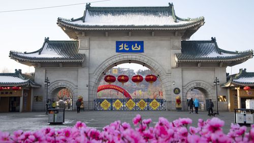 Tourists walk past a gateway with the name "Beishan" seen at the Beishan Park in northeastern China's Jilin province on Jan 23, 2020. Four instructors from Iowa's Cornell College teaching at Beihua University in northeastern China were attacked in the Beishan public park, reportedly with a knife, officials at the U.S. school and the State Department said Tuesday, June 11, 2024. (Zhu Wanchang/CNS Photos via AP)