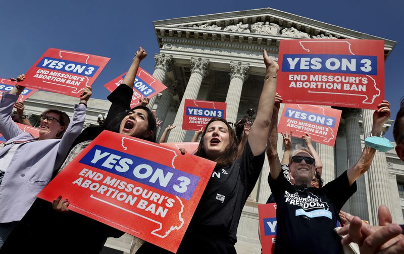 Amendment 3 supporters Luz Maria Henriquez, second from left, executive director of the ACLU Missouri, celebrates with Mallory Schwarz, center, of Abortion Action Missouri, after the Missouri Supreme Court in Jefferson City, Mo., ruled that the amendment to protect abortion rights would stay on the November ballot in on Tuesday, Sept. 10, 2024. (Robert Cohen/St. Louis Post-Dispatch via AP)