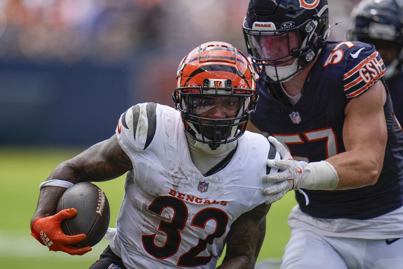 Cincinnati Bengals running back Trayveon Williams (32) runs with the ball against Chicago Bears linebacker Jack Sanborn (57) during the first half of an NFL preseason football game, Saturday, Aug. 17, 2024, at Soldier Field in Chicago. (AP Photo/Erin Hooley)