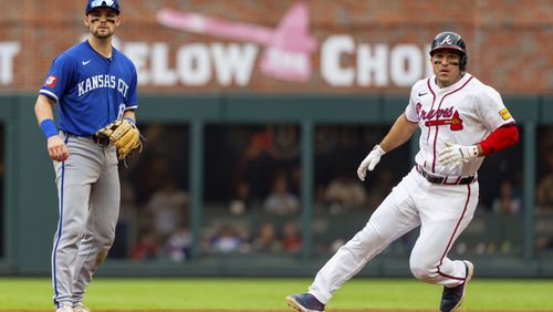 Atlanta Braves' Travis d'Arnaud, right, tags second base after a hit by Atlanta Braves catcher Sean Murphy while Kansas City Royals second baseman Michael Massey, left, waits for the throw to him in the fourth inning of a baseball game, Sunday, Sept. 29, 2024, in Atlanta. (AP Photo/Jason Allen)