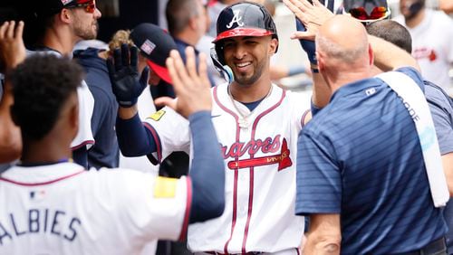 Atlanta Braves outfielder Eddie Rosario (8) gets high fives at the dugout after hitting a two-run home run during the seventh inning against the St. Louis Cardinals at Truist Park on Saturday, July 20, 2024, in Atlanta. 
(Miguel Martinez/ AJC)