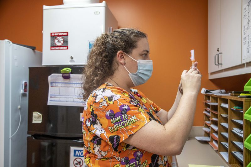  Licensed Practitioner Nurse Brittney Golden prepares an Influenza vaccine for a patient at Conyers Pediatrics in Conyers Wednesday. (Alyssa Pointer/The Atlanta Journal-Constitution)