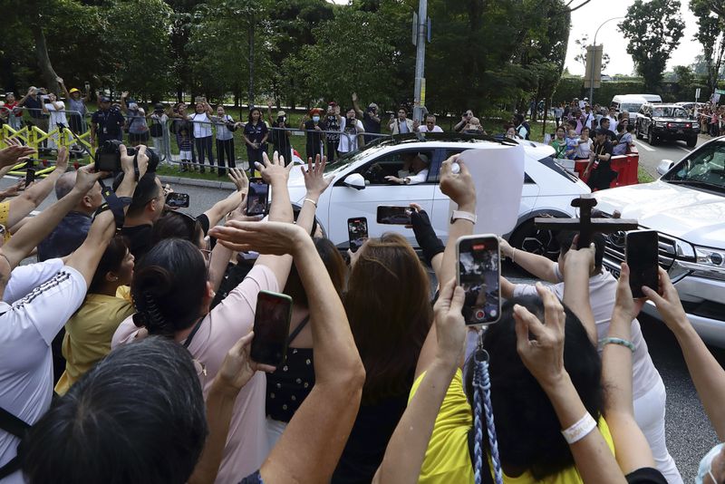 People react as Pope Francis arrives at St Theresa's Home in Singapore, Friday, Sept. 13, 2024. (AP Photo/Suhaimi Abdullah)