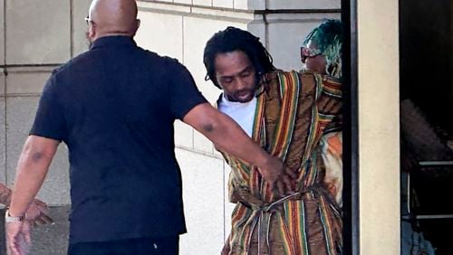 District of Columbia Councilman Trayon White, Sr., center, walks out of the federal courthouse after his initial appearance, Monday, Aug. 19, 2024 in Washington. White was arrested on a federal bribery charge by the FBI on Sunday. (AP Photo/Michael Kunzelman)