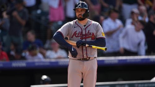 Atlanta Braves' Travis d'Arnaud stands at home plate after striking out against Colorado Rockies relief pitcher Victor Vodnik to end a baseball game Sunday, Aug. 11, 2024, in Denver. (AP Photo/David Zalubowski)