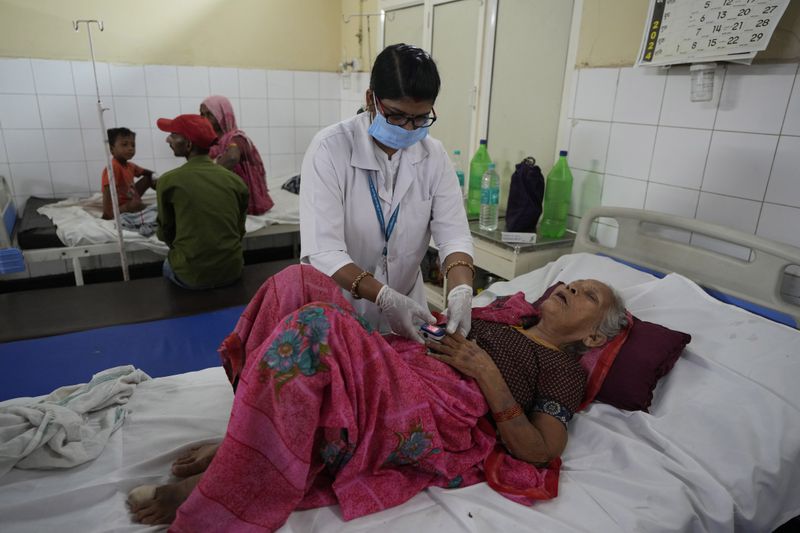 A woman injured in a stampede receives treatment at Hathras district hospital, Uttar Pradesh, India, Wednesday, July 3, 2024. Thousands of people at a religious gathering rushed to leave a makeshift tent, setting off a stampede Tuesday that killed more than hundred people and injured scores. (AP Photo/Rajesh Kumar Singh)