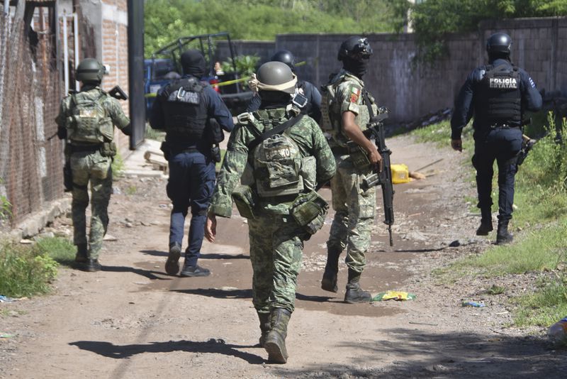 Soldiers and police arrive at the area where bodies lie on the ground in Culiacan, Sinaloa state, Mexico, Tuesday, Sept. 17, 2024. (AP Photo)