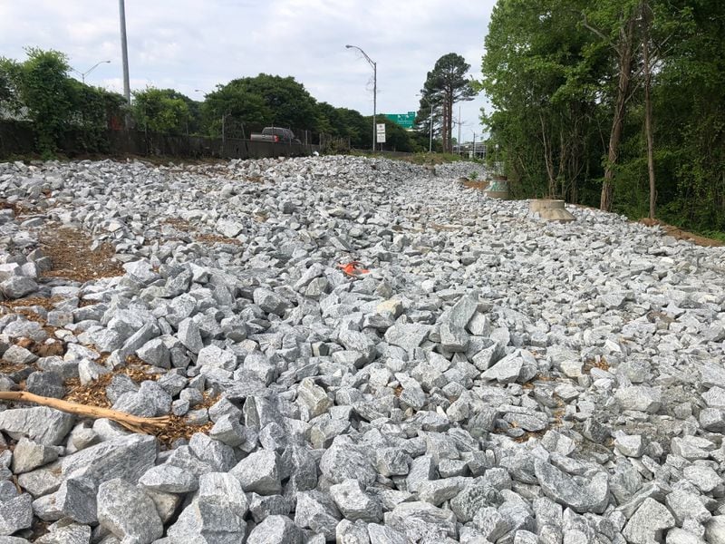 After the city cleared an encampment near Cheshire Bridge, The Atlanta Journal-Constitution observed rocks on a verge where people had pitched tents. (Matt Reynolds with The Atlanta Journal-Constitution)