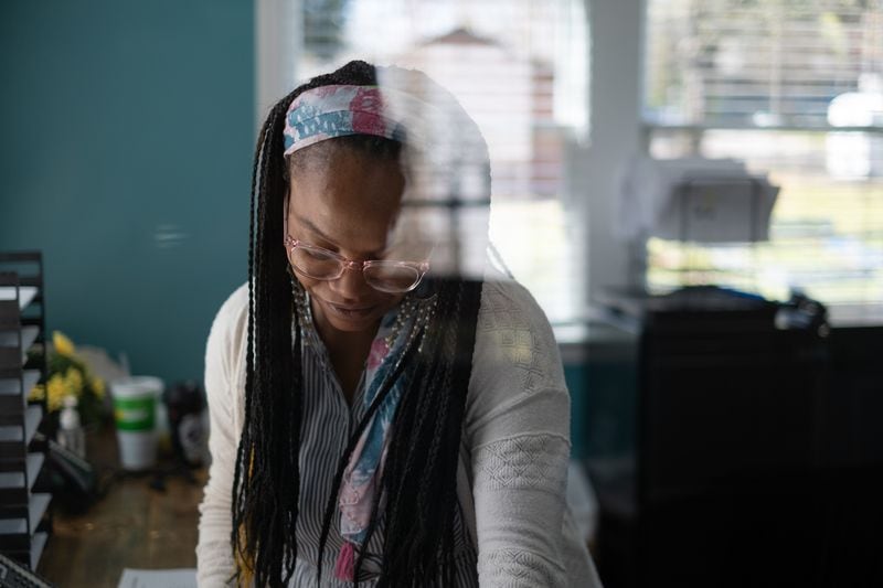 Sonia Doyle works at Emmaus House before picking her son Cash Bufford, 6, up from kindergarten at Wesley International Academy in Atlanta on Monday, March 21, 2022. Ben Gray for The Atlanta Journal-Constitution