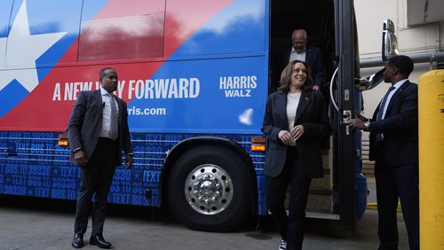 Democratic presidential nominee Vice President Kamala Harris and her running mate Minnesota Gov. Tim Walz exit their campaign bus in Savannah, Ga., Wednesday, Aug. 28, 2024. (AP Photo/Jacquelyn Martin)