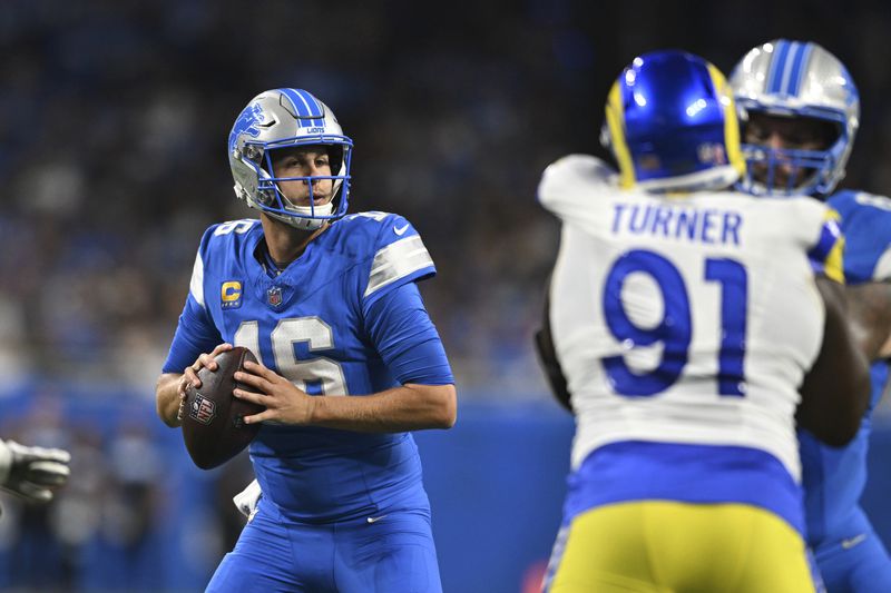 Detroit Lions quarterback Jared Goff (16) looks to throw against the Los Angeles Rams during the first half of an NFL football game in Detroit, Sunday, Sept. 8, 2024. (AP Photo/David Dermer)