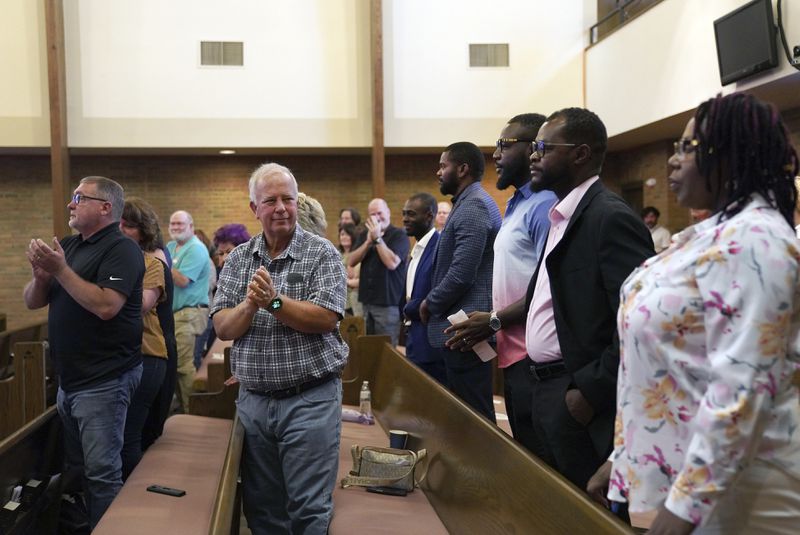 Central Christian Church congregants stand to applaud members of the Haitian community during service, on Sunday, Sept. 15, 2024, in Springfield, Ohio. (AP Photo/Jessie Wardarski)