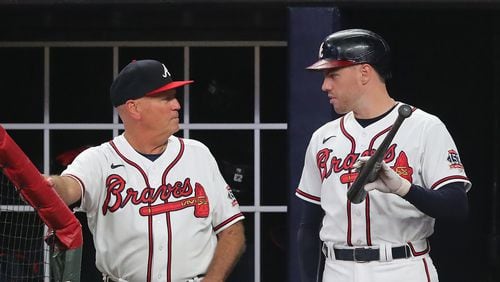 072021 Atlanta: Atlanta Braves manager Brian Snitker and first baseman Freddie Freeman confer in the dugout during the 7th innng during a 2-1 victory against the San Diego Padres in a MLB baseball game on Tuesday, July 20, 2021, in Atlanta.   “Curtis Compton / Curtis.Compton@ajc.com”